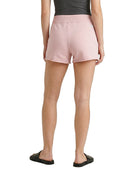 Person wearing pink shorts on a white background