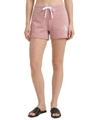Person wearing pink shorts with a logo on a white background