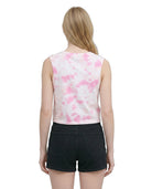 Woman wearing a sleeveless top with pink floral pattern and black shorts on a white background