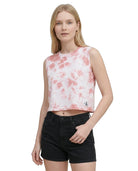 Woman wearing a tie-dye crop top with a brand logo on a white background