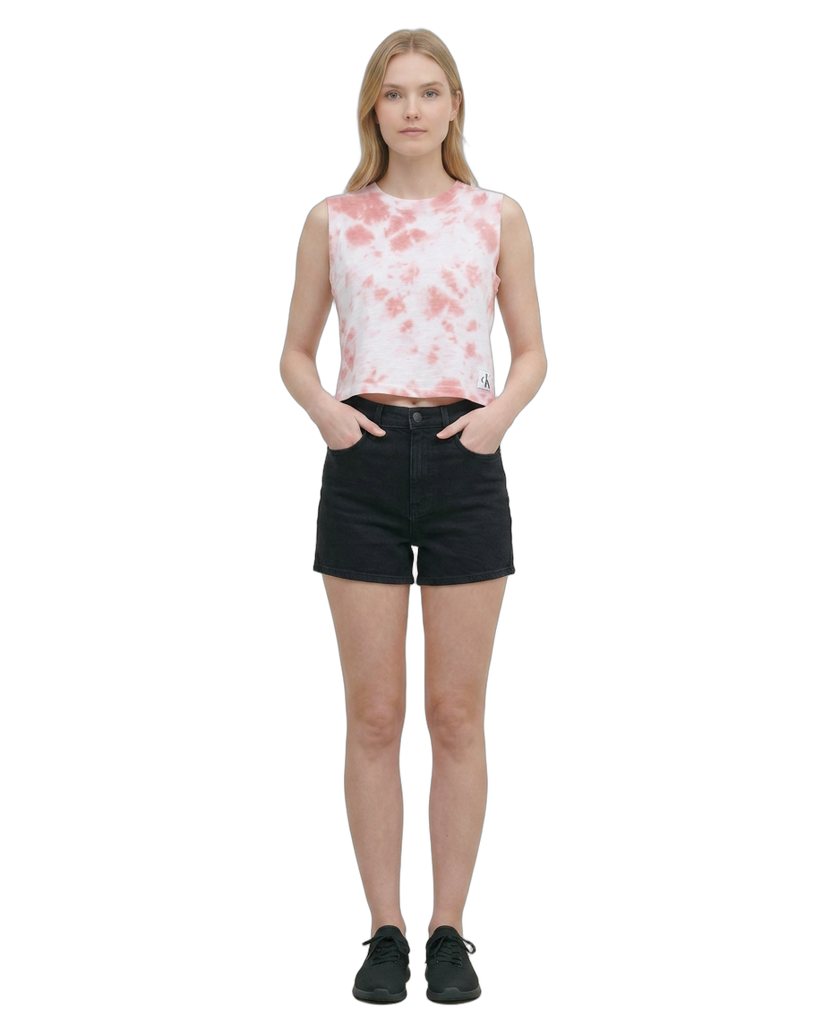 Woman wearing a sleeveless floral top and black shorts on a white background