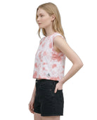 Woman wearing a tie-dye tank top with a brand logo on a white background