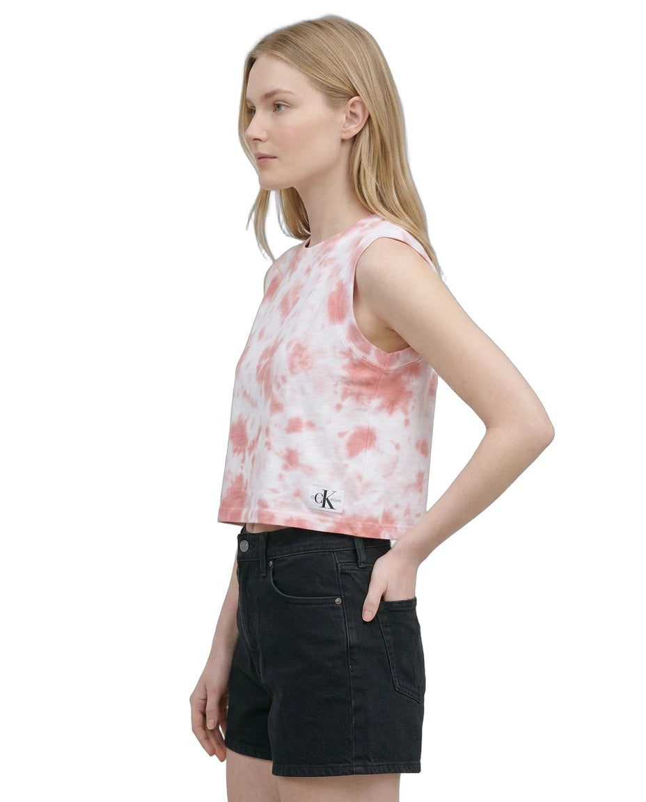 Woman wearing a tie-dye tank top with a brand logo on a white background