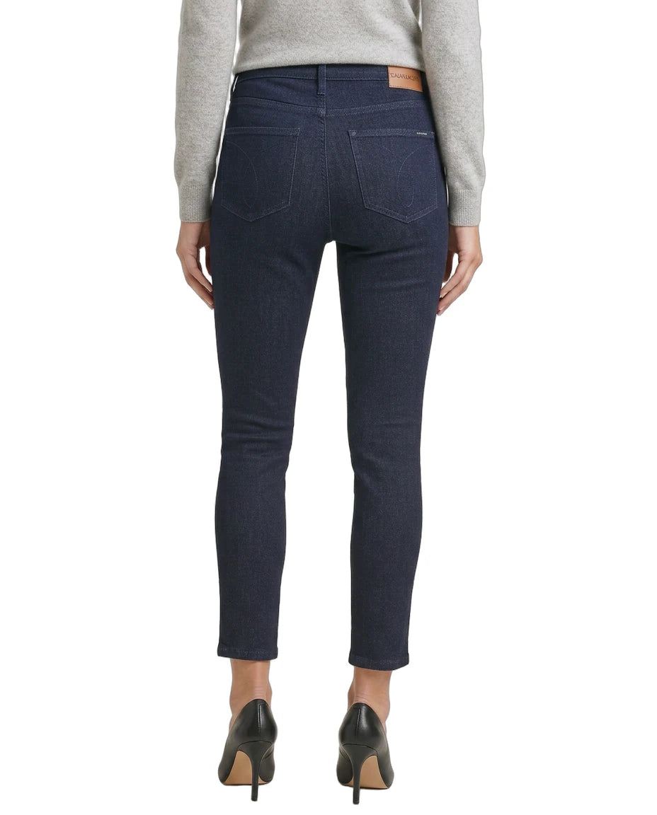 Person wearing dark blue jeans on a white background