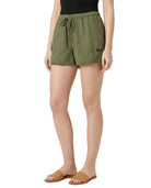 Person wearing green shorts on a white background