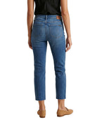 Person wearing blue jeans on a white background