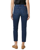 Person wearing blue jeans on a white background