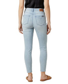 Light blue jeans worn by a person on a white background