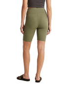 Person wearing olive green shorts on a white background