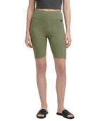 Person wearing green shorts on a white background