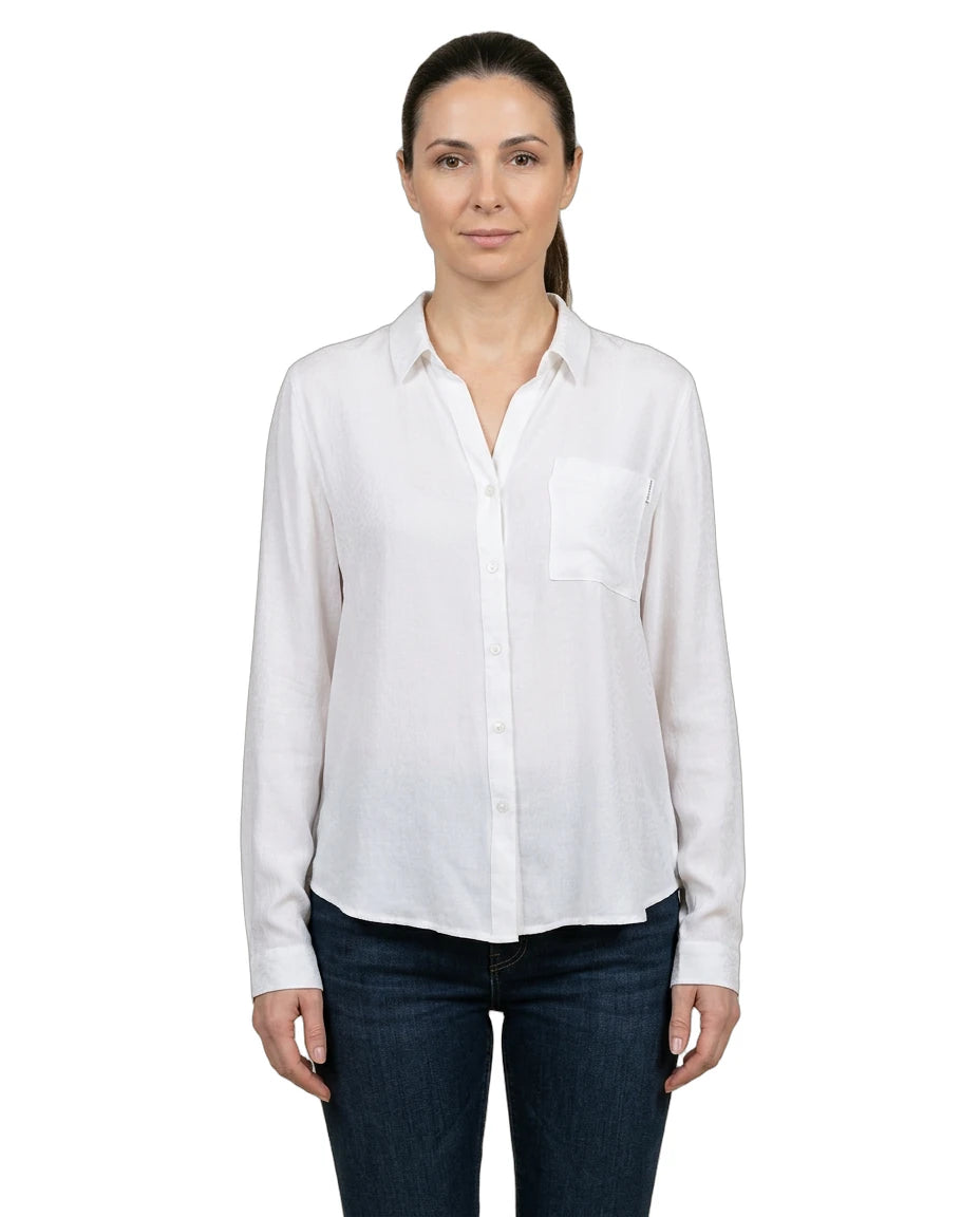 Woman wearing a white shirt and dark jeans on a white background