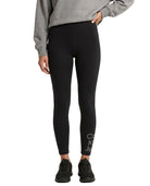 Person wearing black Calvin Klein leggings with text and a gray sweatshirt on a white background