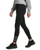 Person wearing black Calvin Klein leggings on a white background
