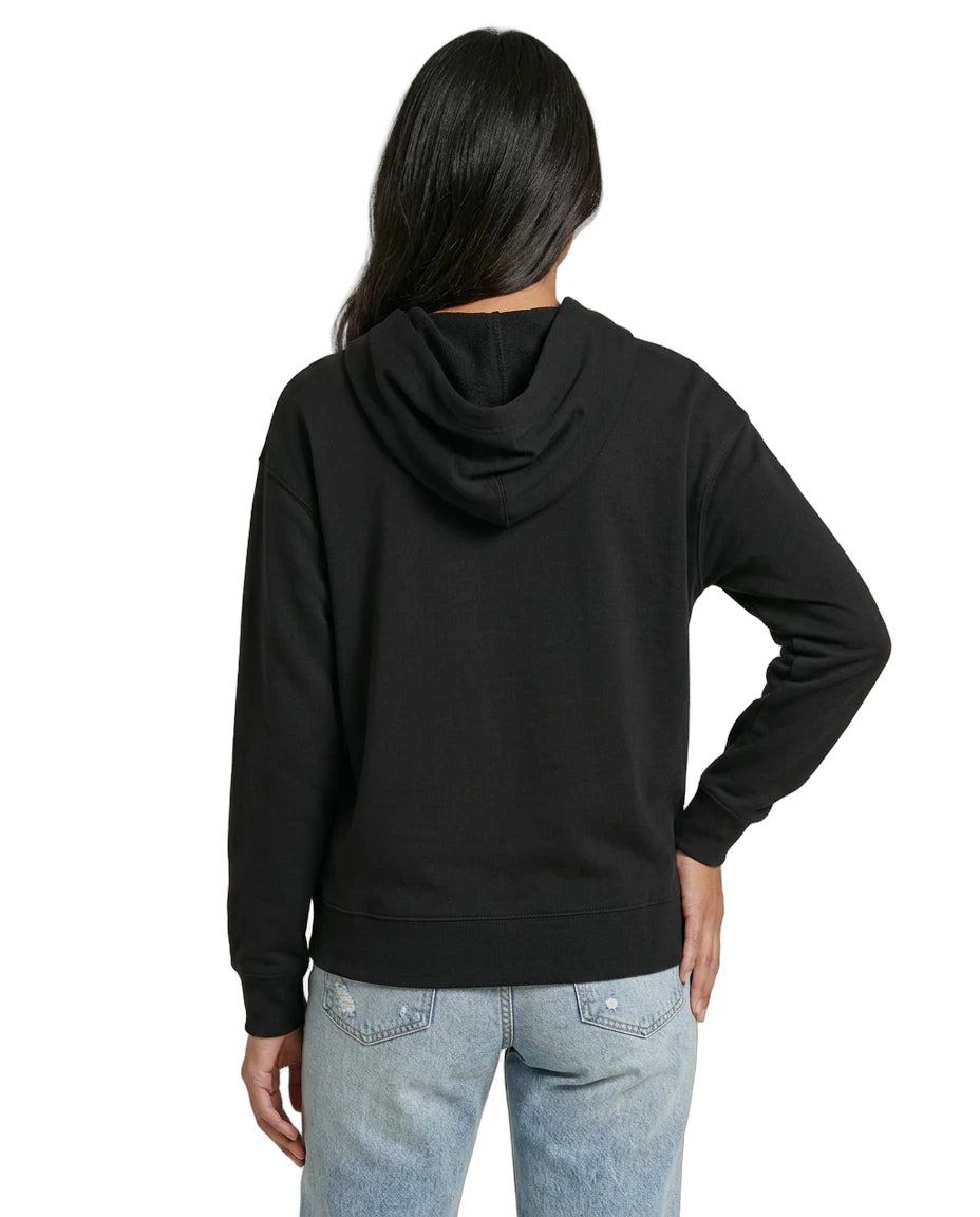 Woman wearing a black Calvin Klein hoodie with colorful text design on a white background seen from the back