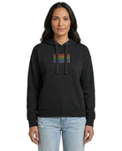 Person wearing a black Calvin Klein hoodie with colorful text design on a white background