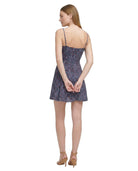 Woman wearing a patterned Calvin Klein dress on a white background