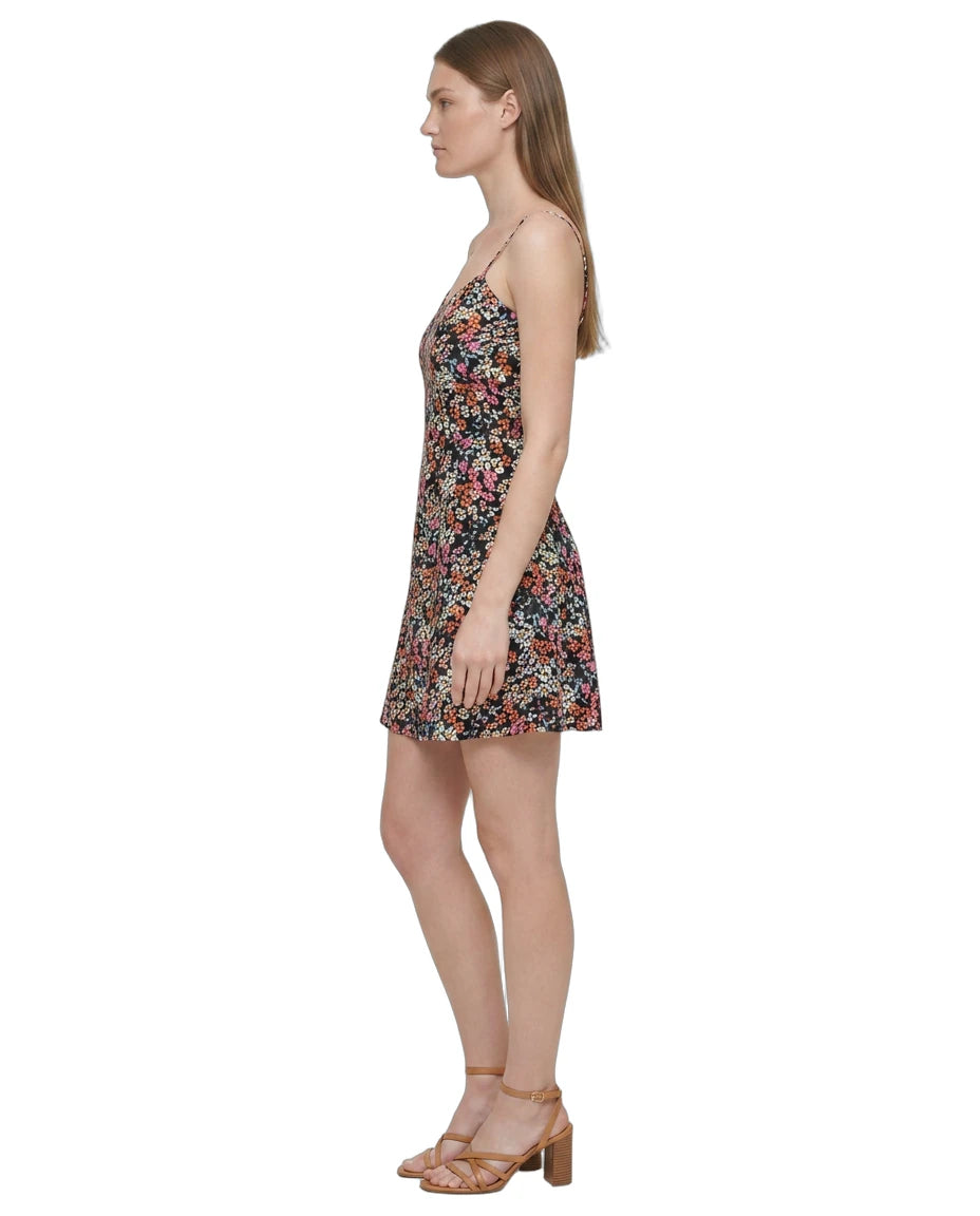 Woman wearing a floral Calvin Klein dress on a white background