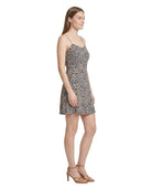 Woman wearing a floral Calvin Klein dress on a white background