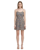 Woman wearing a floral Calvin Klein dress on a white background