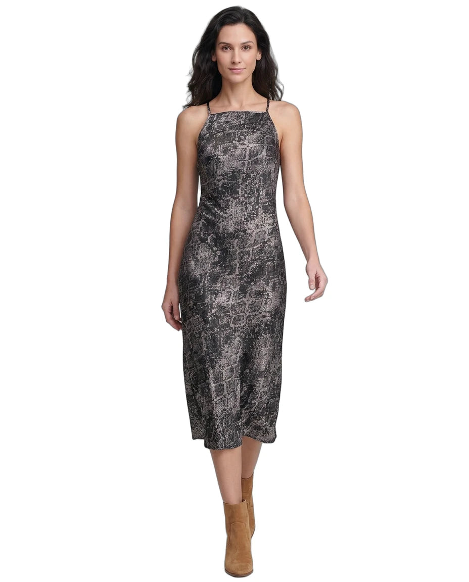 Woman wearing a patterned Calvin Klein dress on a white background