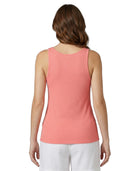 Woman wearing a coral Calvin Klein tank top on a white background