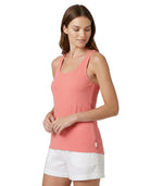 Woman wearing a coral Calvin Klein tank top on a white background