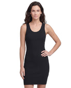 Woman wearing a black ribbed Calvin Klein dress on a white background