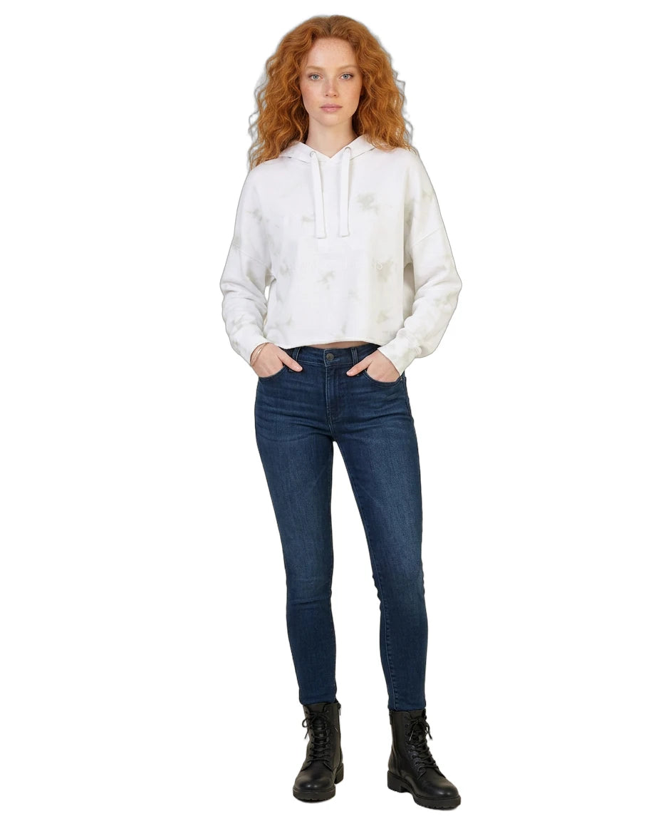 Woman wearing a white Calvin Klein hoodie and blue jeans on a white background