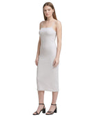 Woman wearing a white Calvin Klein dress on a white background