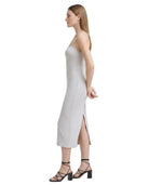 Woman wearing a white Calvin Klein dress on a white background