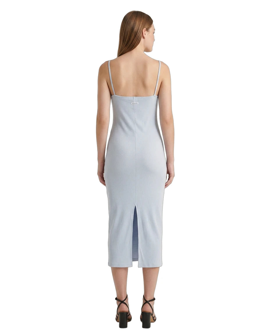 Woman wearing a light blue Calvin Klein dress on a white background