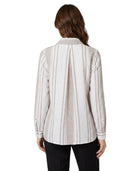 Woman wearing a striped Calvin Klein shirt on a white background