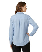 Woman wearing a light blue Calvin Klein shirt on a white background