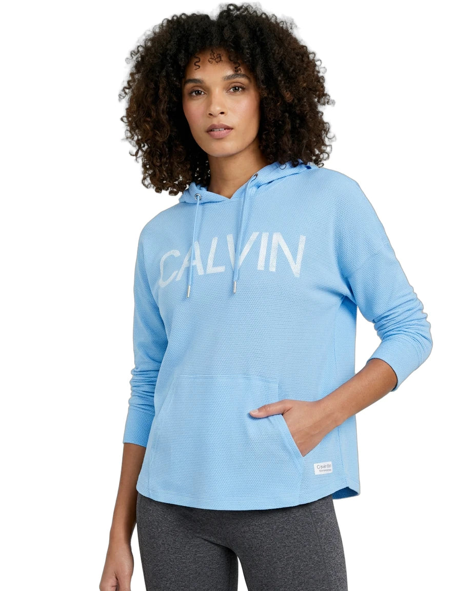 Woman wearing a blue Calvin Klein hoodie on a white background