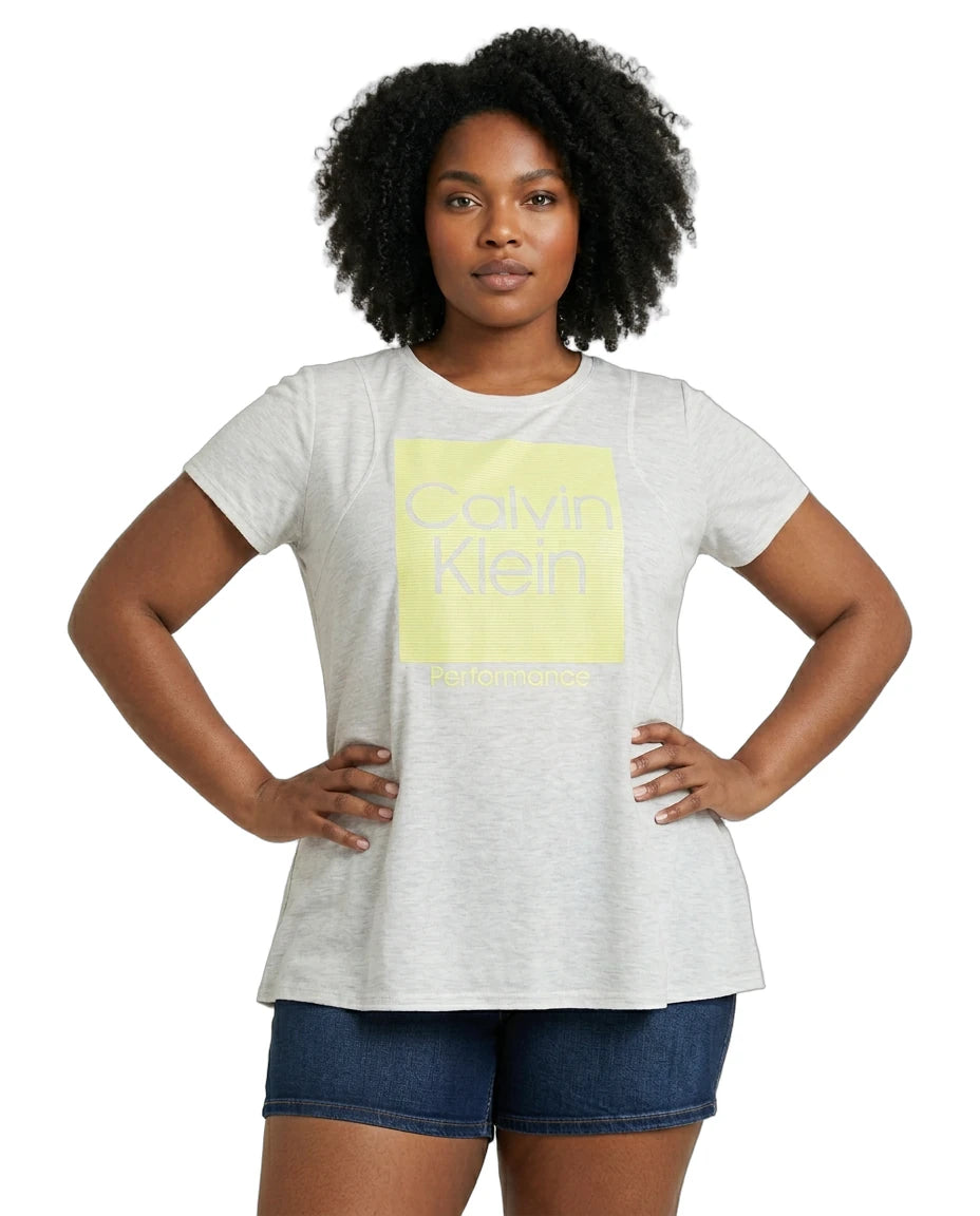 Woman wearing a Calvin Klein t-shirt with a yellow logo on a white background