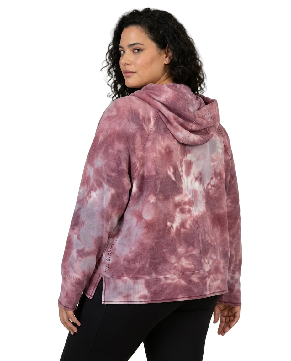 Person wearing a pink tie-dye hoodie on a white background