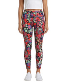 Person wearing colorful floral Calvin Klein leggings on a white background