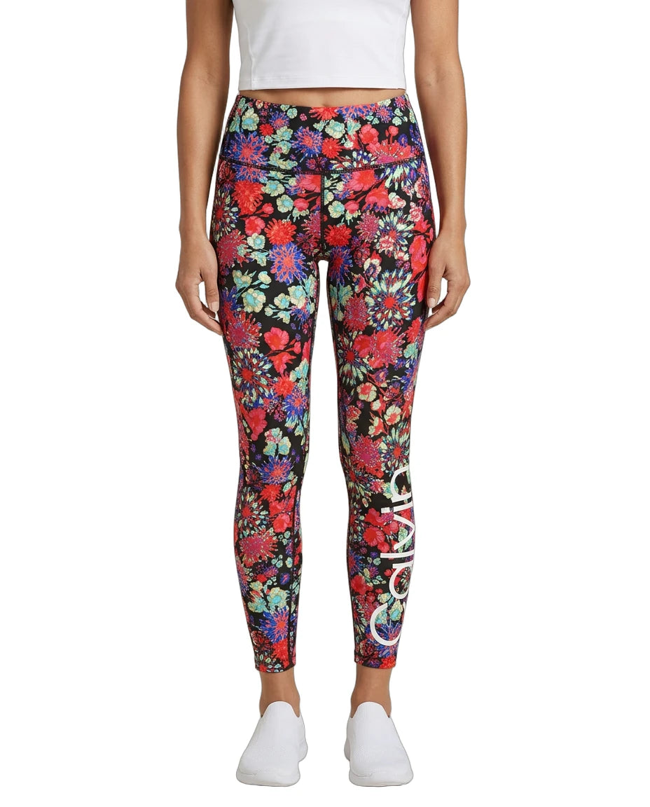 Person wearing colorful floral Calvin Klein leggings on a white background