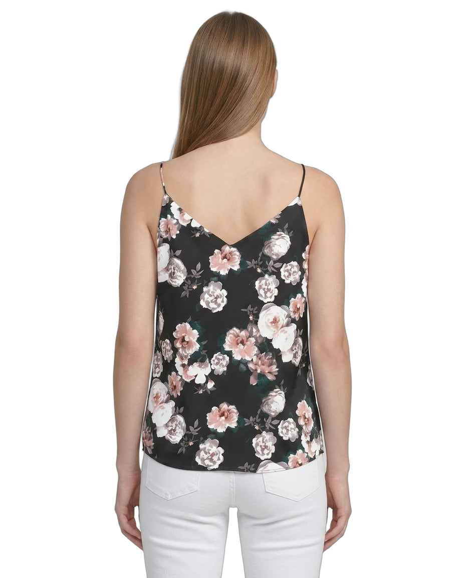 Woman wearing a floral camisole top on a white background