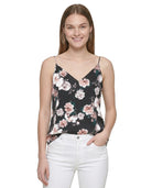 Woman wearing a floral camisole top on a white background