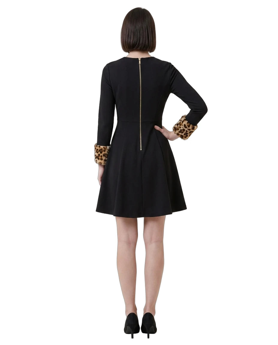 Black Calvin Klein dress with leopard print cuffs worn by a model on a white background
