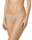Beige lace underwear worn by a model on a white background