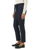 Navy pants with a belt worn by a person on a white background