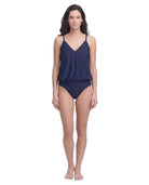Woman wearing a navy blue swimsuit on a white background