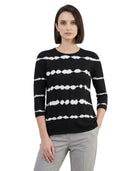 Woman wearing a black sweater with white stripe pattern on a white background