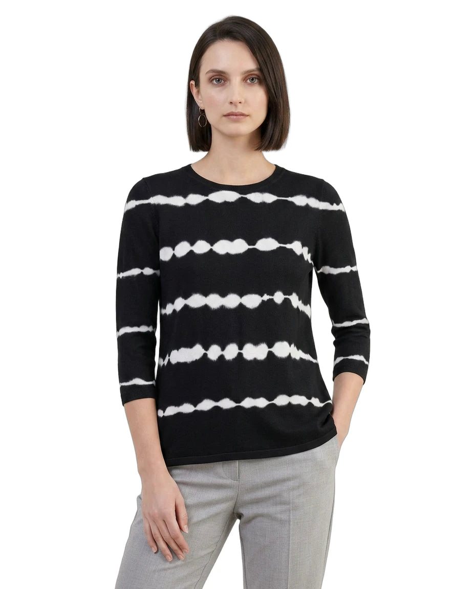 Woman wearing a black sweater with white stripe pattern on a white background
