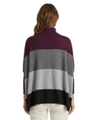 Woman wearing a color-blocked Calvin Klein sweater with a white background