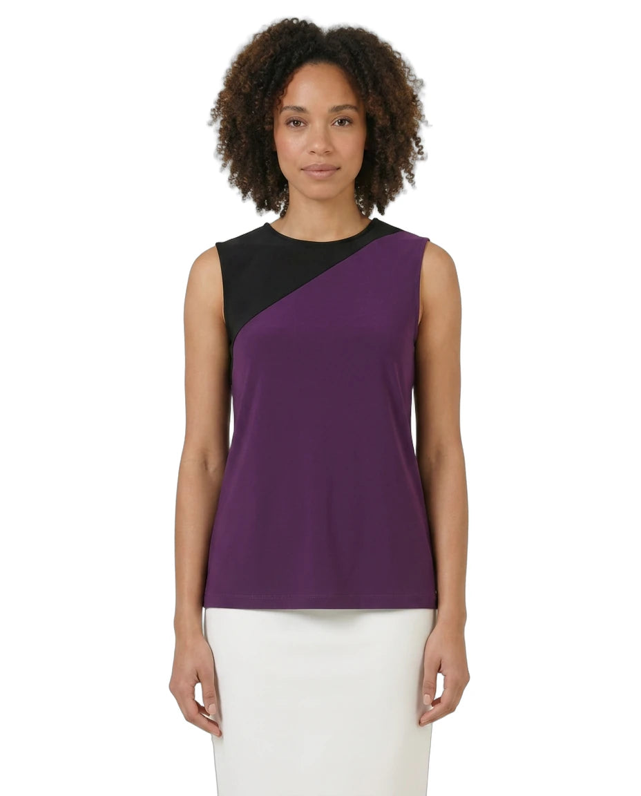Woman wearing a sleeveless purple and black top on a white background