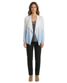 Woman wearing a gradient cardigan over a gray top and black pants on a white background