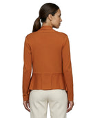 Woman wearing an orange peplum Calvin Klein cardigan on a white background